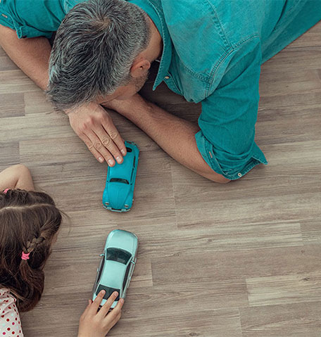 Father and daughter playing car toy | ICC Floors Plus