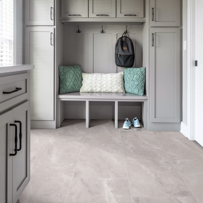 Mudroom with beige tile flooring and built-in storage bench